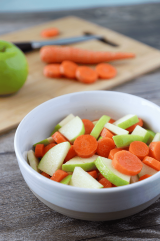 Carrot and apple salad in a white bowl