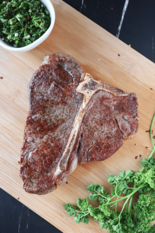 T-bone steak on a cutting board.